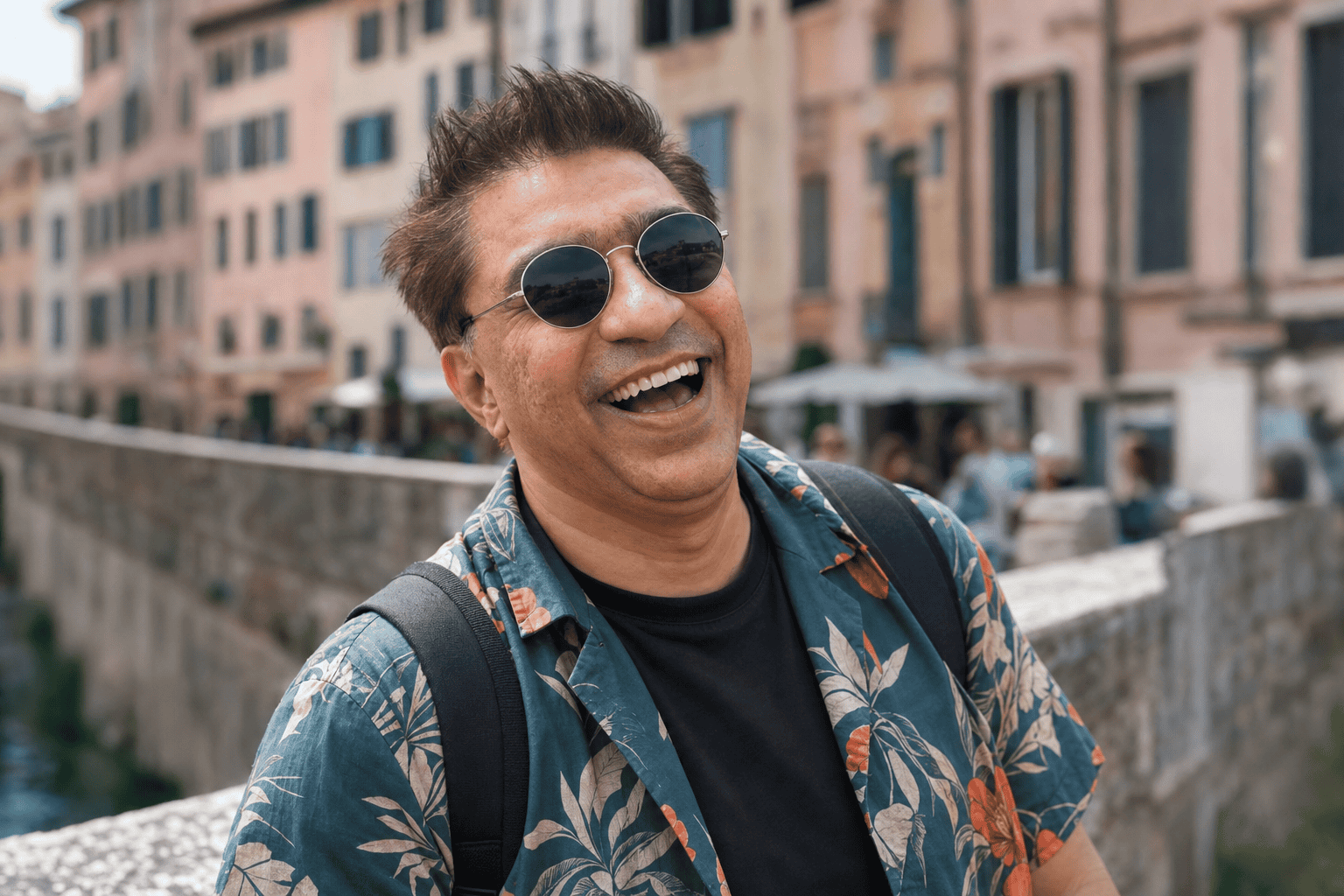 AI image prompt result — candid close-up travel portrait laughing with sunglasses on a pastel European street